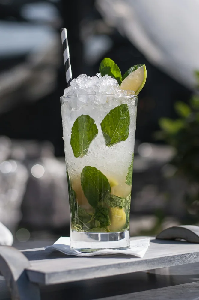 A lime and mint drink photographed over crushed ice